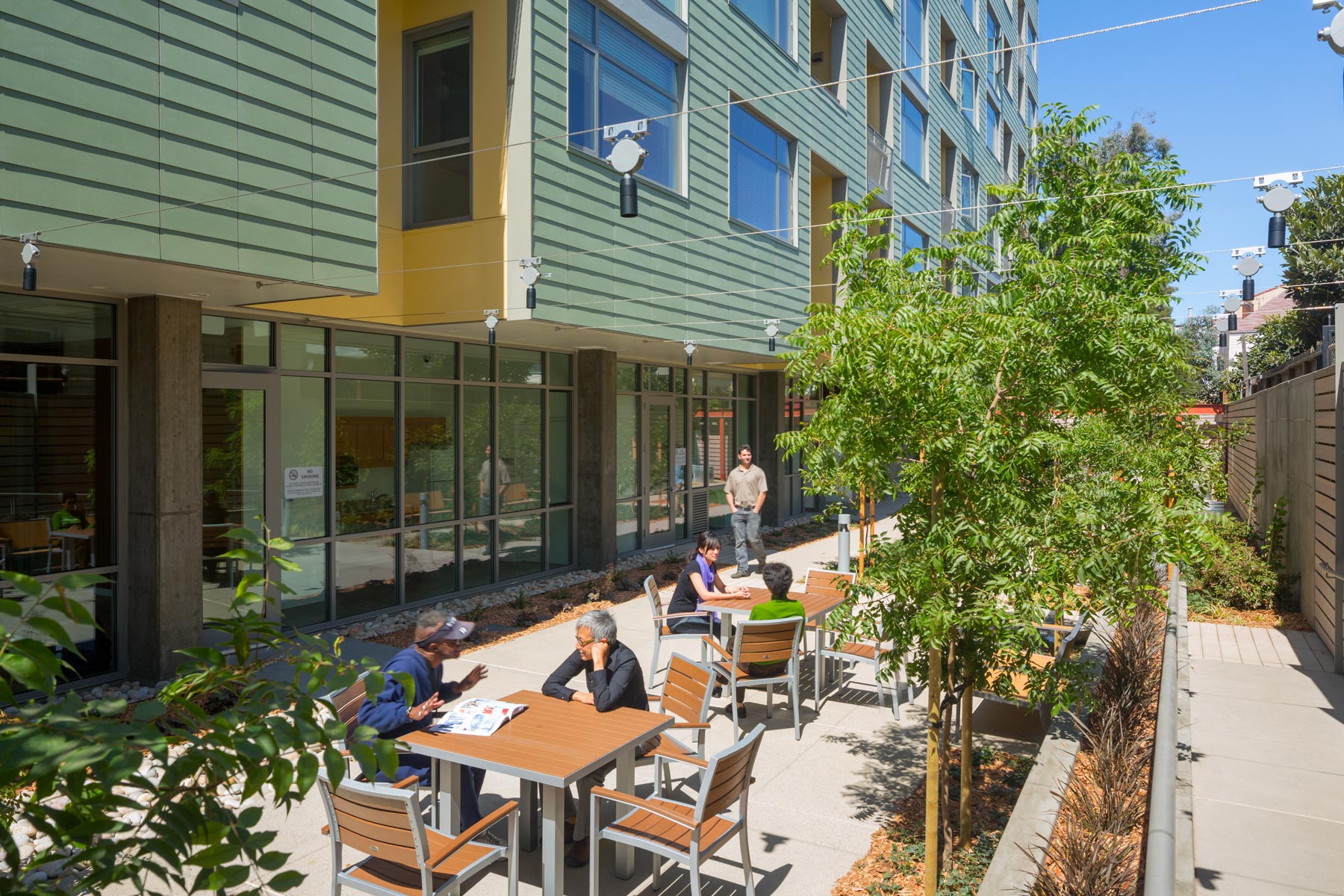 Merritt Crossing is a Green Point rated and LEED Platinum certified affordable housing building for seniors, a model of sustainable design in an urban area of Oakland in the Bay Area.